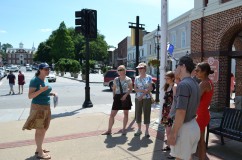 A tour guide with the Newport Restoration Foundation discusses the history of Washington Square.