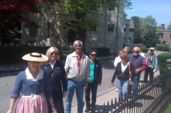 Following a guide in colonial costume during the Tour of the Month, this group surveys the Historic Hill.